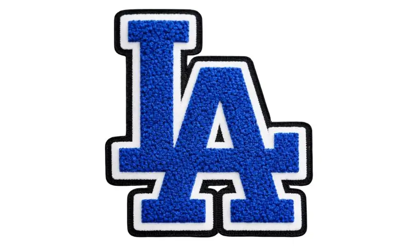 high-quality blue chenille varsity patch in the shape of the interlocking LA logo, featuring a fuzzy 3D texture and a black embroidered border.