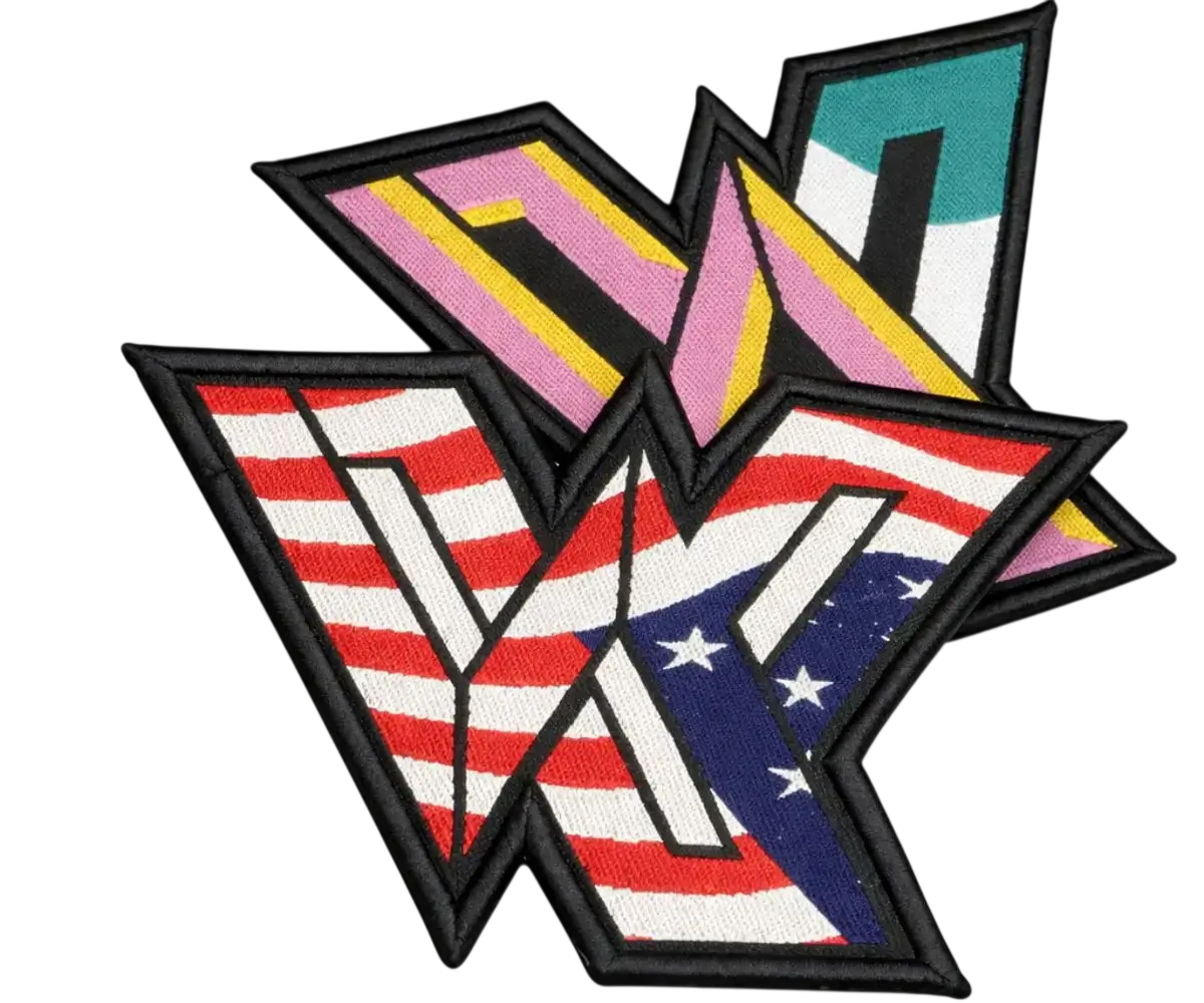 Two custom-shaped woven patches with a flat, smooth texture and high-definition detail. One features a crisp American flag design and the other a vibrant geometric pattern, both finished with a thick black satin border and clean die-cut edges.