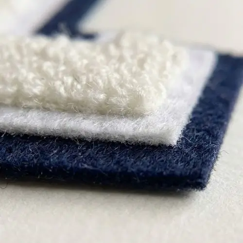 Macro view of a double-felt backing stack on a custom varsity chenille patch showing construction layers.