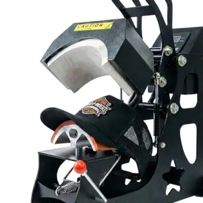 Professional industrial hat heat-press with a curved platen applying a custom patch to a black trucker hat in a Los Angeles factory.