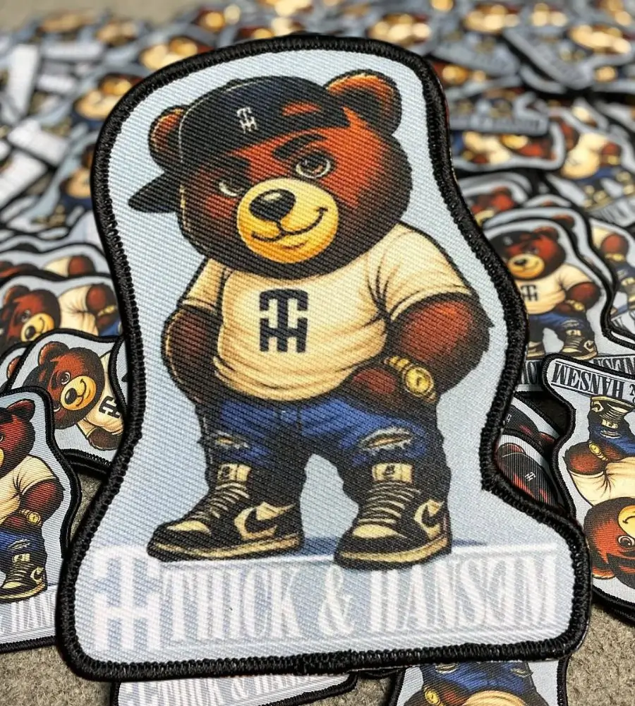 Bulk production run of custom printed patches featuring a streetwear bear mascot. The design demonstrates high-resolution gradients and shading that traditional embroidery cannot achieve.