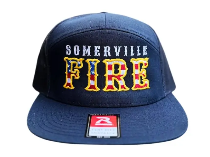 Structured navy blue Richardson 112 trucker hat with large custom fire department embroidery on the stiff front panel.