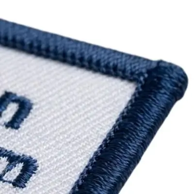 Custom patch featuring an embroidered satin-stitch overlay border for a premium finished look.