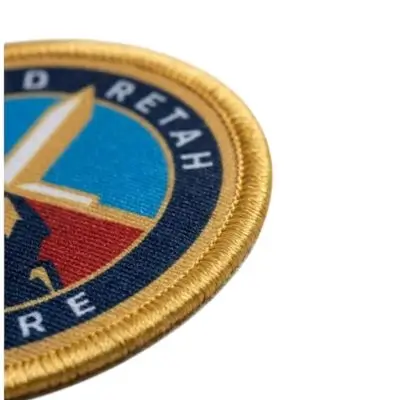 Printed patch with an embroidered border stitched on top of the design for added depth.