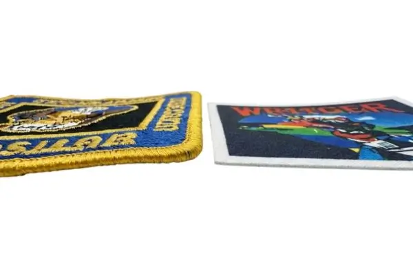 Side profile showing the 3D raised stitching of an embroidered patch versus the flush, flat finish of a printed patch.