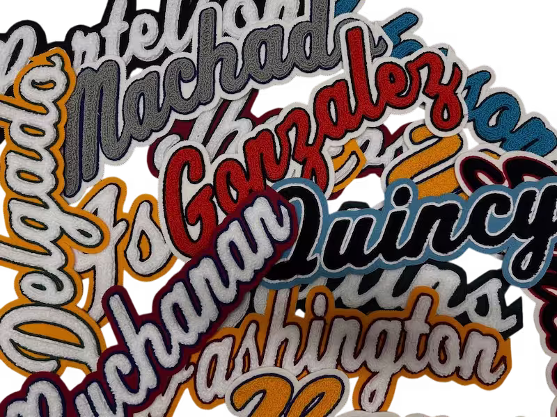 Bulk collection of custom script name chenille patches featuring high-pile moss stitch and double-felt borders.